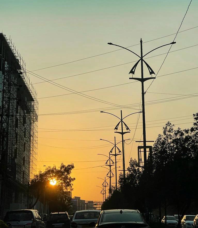Vehicles on a road during sunset, symbolizing the rush of daily life and the need for a pause.